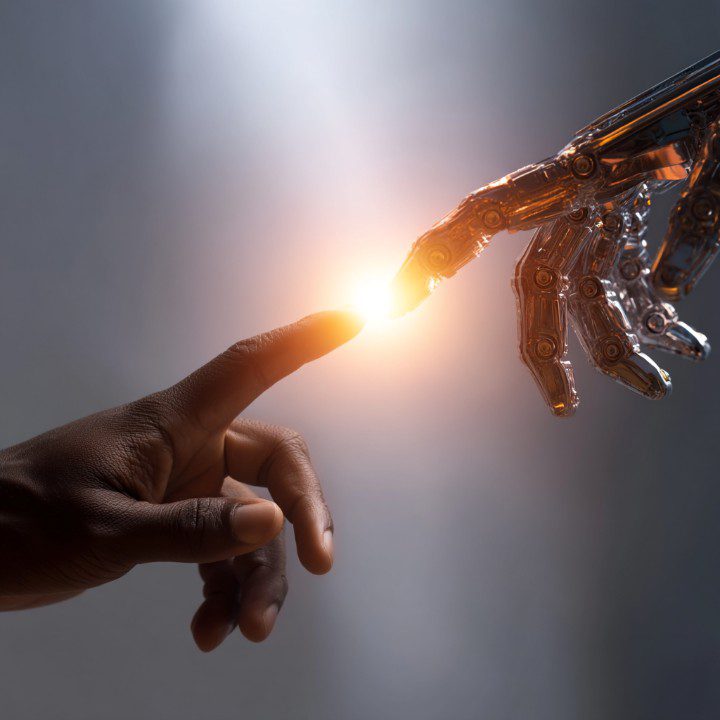 A human hand and a robotic hand reaching toward each other with a glowing light between them, symbolizing AI and human interaction.