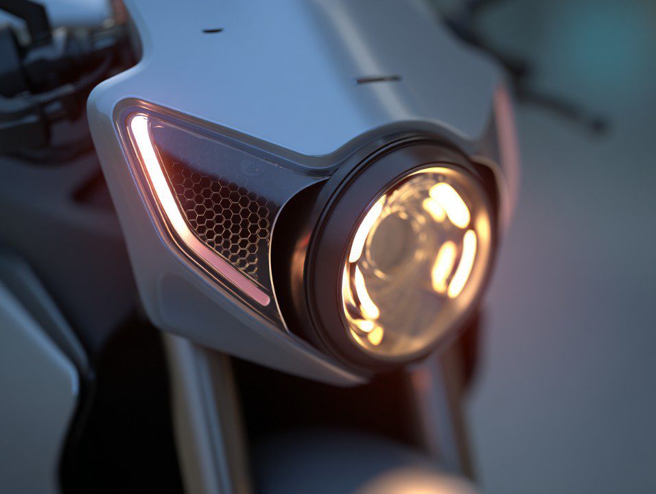 High-tech motorcycle headlight glowing with modern lighting design and honeycomb accents in a sleek futuristic build.