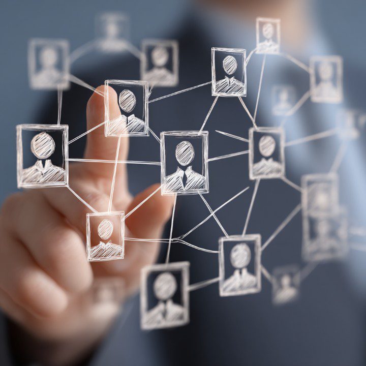 Businessperson interacting with a digital HR interface showing sketched employee avatars connected in a network.