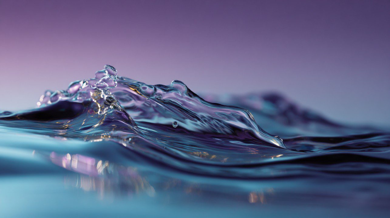 A close-up view of a water splash with flowing motion captured against a smooth purple gradient background, symbolizing clarity and purity.