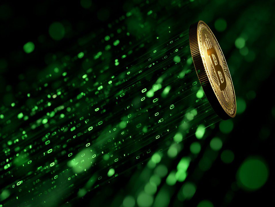 Glowing Bitcoin coin flying through a green digital matrix of binary code, symbolizing blockchain and cryptocurrency tech.
