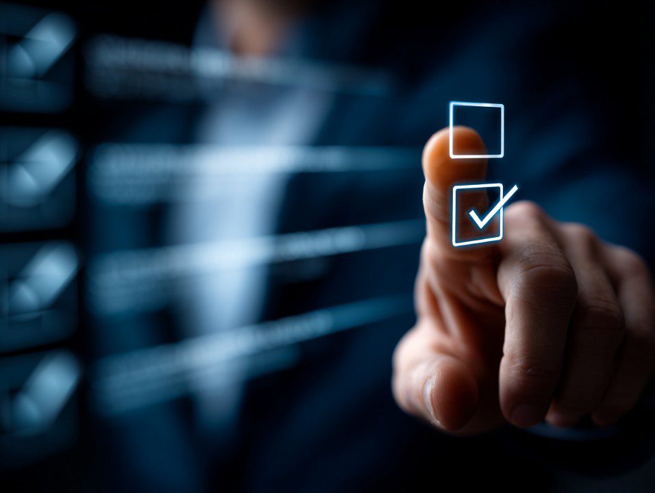 Businessman taps a glowing virtual checkbox on a digital screen, representing task management and workflow automation.