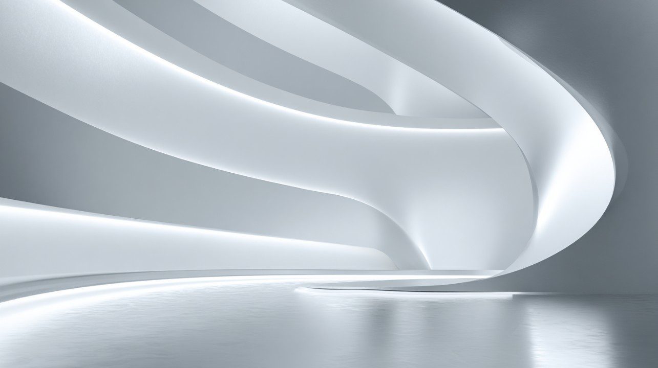 Clean modern interior space with smooth curved silver and white architectural design and ambient lighting.
