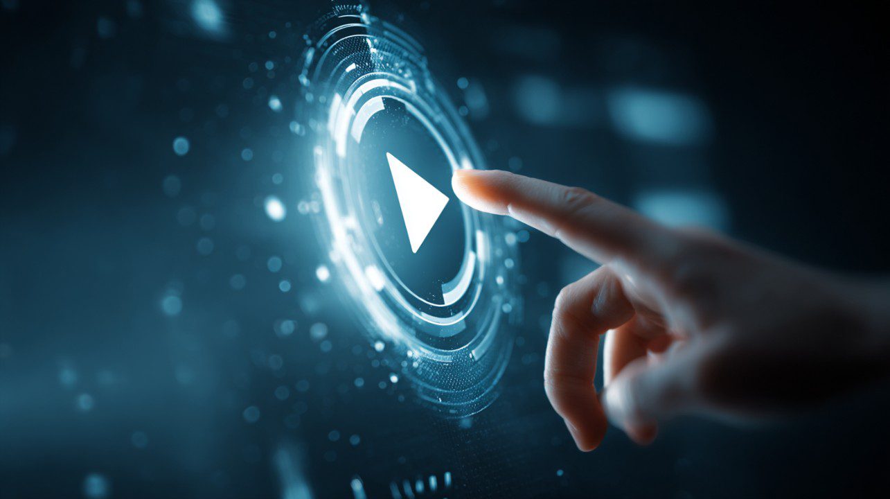 A glowing digital play button on a futuristic interface being activated by a human hand, symbolizing tech and media interaction.