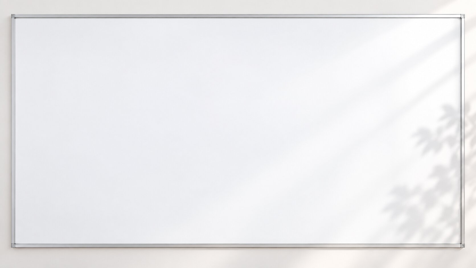 Matching whiteboard content background with a silver frame, subtle plant shadows, and ample clean writing space.